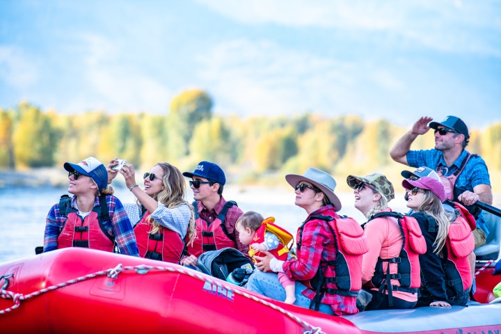 a group of people riding on the back of a boat